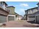 Exterior showcasing a community of homes with well-kept brick driveways and green spaces at 19055 E 55Th Ave, Denver, CO 80249