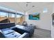 Bright living room with high ceilings, a large window, and a comfortable blue sectional sofa at 19055 E 55Th Ave, Denver, CO 80249