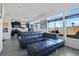 Open-concept living room featuring a comfortable sectional sofa and a view of the modern kitchen at 19055 E 55Th Ave, Denver, CO 80249