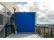 Private balcony with a blue privacy screen, city views, and a decorative planter at 3198 Blake St # 502, Denver, CO 80205