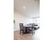 Open floor plan with dining table, chairs, and a leather couch under bright lighting at 3198 Blake St # 502, Denver, CO 80205