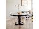 Dining area featuring a round table, transparent chairs, and modern decor at 3198 Blake St # 502, Denver, CO 80205