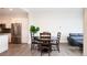 Cozy dining area with a dark round table and matching chairs near stainless steel kitchen appliances at 3198 Blake St # 502, Denver, CO 80205