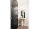 Modern half bathroom features a sleek pedestal sink, stylish black door, and contemporary fixtures at 3198 Blake St # 502, Denver, CO 80205