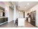 Bright kitchen with stainless steel appliances, granite countertops, and a kitchen island with stools at 3198 Blake St # 502, Denver, CO 80205