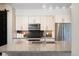 Modern kitchen island with granite countertop, a sink, and stainless steel appliances at 3198 Blake St # 502, Denver, CO 80205