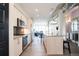Open concept kitchen with stainless steel appliances, island with granite countertop, and dining area at 3198 Blake St # 502, Denver, CO 80205