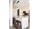 Modern kitchen island with a granite countertop, stools, and elegant lighting at 3198 Blake St # 502, Denver, CO 80205