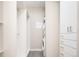 Well-organized laundry room with stacked washer/dryer and built-in storage cabinets and open shelving for convenience at 3198 Blake St # 502, Denver, CO 80205