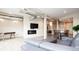 Open floor plan featuring a living room with a fireplace, media center, and adjacent dining area at 3198 Blake St # 502, Denver, CO 80205
