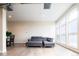 Bright living room featuring hardwood floors, large windows, and comfortable gray sectional sofa at 3198 Blake St # 502, Denver, CO 80205