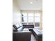 Comfortable living room featuring a leather sectional sofa with an ottoman and big windows at 3198 Blake St # 502, Denver, CO 80205