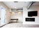 Modern living room with stylish fireplace, television, exposed ductwork, and sleek, minimalist furniture at 3198 Blake St # 502, Denver, CO 80205
