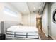 Bedroom with a comfortable bed and an ensuite bathroom with a shower at 3198 Blake St # 502, Denver, CO 80205