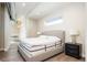 Bedroom with a comfortable bed, stylish nightstand, modern lamp, and view of the hallway at 3198 Blake St # 502, Denver, CO 80205