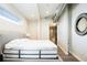 Bedroom with bed, a modern mirror, and an ensuite bathroom with glass shower doors at 3198 Blake St # 502, Denver, CO 80205