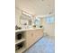 Modern bathroom featuring a double vanity, stylish mirrors, and patterned tile floor at 1630 S Valentine Way, Lakewood, CO 80228