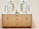 Modern bathroom vanity with double sinks, gold accents, and ample storage space at 1630 S Valentine Way, Lakewood, CO 80228