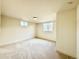 Bright bedroom with neutral walls, plush carpet, and natural light from two windows at 1630 S Valentine Way, Lakewood, CO 80228