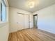 Empty room with neutral walls, wood floors, window, closet, and modern lighting at 1630 S Valentine Way, Lakewood, CO 80228