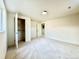 Bright bedroom featuring neutral carpet, an open closet, and a minimalist aesthetic at 1630 S Valentine Way, Lakewood, CO 80228