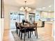 Light-filled dining room connects to the kitchen and features a modern chandelier and sliding glass door at 1630 S Valentine Way, Lakewood, CO 80228