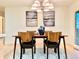 Inviting dining area features modern chandelier, wood table with seating for four, and stylish decor at 1630 S Valentine Way, Lakewood, CO 80228