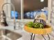 Close-up of kitchen sink area with a view out the window, modern faucet, and stylish accents at 1630 S Valentine Way, Lakewood, CO 80228