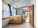Bathroom featuring tile floors, wood vanity, and natural light from window at 3299 Lowell Blvd # 204, Denver, CO 80211