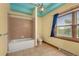 The bathroom has a tub with shower, a toilet, and a window at 3299 Lowell Blvd # 204, Denver, CO 80211