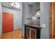 Welcoming entryway boasts a red door, wood floors, beverage cooler, and industrial style light fixture at 3299 Lowell Blvd # 204, Denver, CO 80211