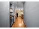 Long hallway boasts wood floors, industrial style lighting, and access to the kitchen at 3299 Lowell Blvd # 204, Denver, CO 80211