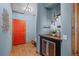 Hallway with a red door, wood floors, and a built in wine cooler at 3299 Lowell Blvd # 204, Denver, CO 80211
