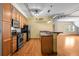 A well-equipped kitchen features wooden cabinets, stainless steel appliances, and a breakfast bar with granite countertops at 3299 Lowell Blvd # 204, Denver, CO 80211