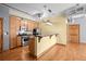 The open concept kitchen features stainless-steel appliances, a breakfast bar, and wood cabinets at 3299 Lowell Blvd # 204, Denver, CO 80211