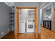 Laundry area featuring a washer, dryer, shelves, and a wine fridge at 3299 Lowell Blvd # 204, Denver, CO 80211