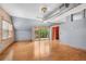 Spacious living area with balcony access, brick accent wall, exposed duct work, and an industrial-style ceiling fan at 3299 Lowell Blvd # 204, Denver, CO 80211