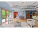 Open-concept living room features hardwood floors, stylish furniture, and access to a bedroom and kitchen at 3299 Lowell Blvd # 204, Denver, CO 80211