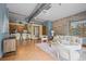 Cozy living room with kitchen view, open layout, exposed ductwork, and brick wall accents at 3299 Lowell Blvd # 204, Denver, CO 80211