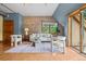 Inviting living room with exposed brick accent wall, lots of natural light, and chic, comfortable furniture at 3299 Lowell Blvd # 204, Denver, CO 80211