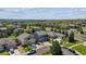 Aerial view of the home showcases its well-maintained yard, driveway, and proximity to neighborhood amenities and roads at 11866 High Desert Rd, Parker, CO 80134