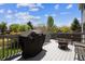 Back deck with a grill, outdoor seating, and a relaxing fire pit at 11866 High Desert Rd, Parker, CO 80134