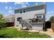 Back exterior of house features a deck with stairs leading to a well-manicured lawn at 11866 High Desert Rd, Parker, CO 80134