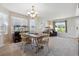 Well-lit dining room with wooden table set, perfect for Gathering meals and entertaining at 11866 High Desert Rd, Parker, CO 80134