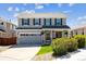 Charming two-story home features a well-manicured lawn, grey siding, and a welcoming front porch at 11866 High Desert Rd, Parker, CO 80134