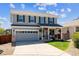 Charming two-story home features a well-manicured lawn, grey siding, and a welcoming front porch at 11866 High Desert Rd, Parker, CO 80134