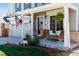 Inviting covered front porch features comfortable seating, plants, and stylish decor at 11866 High Desert Rd, Parker, CO 80134
