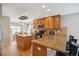 Open kitchen has granite countertops, wooden cabinets, and stainless steel appliances at 11866 High Desert Rd, Parker, CO 80134