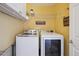Efficient laundry room with modern side-by-side washer and dryer and storage shelves at 11866 High Desert Rd, Parker, CO 80134