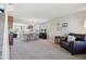 Open-concept living room with neutral carpet, providing seamless flow to dining area at 11866 High Desert Rd, Parker, CO 80134